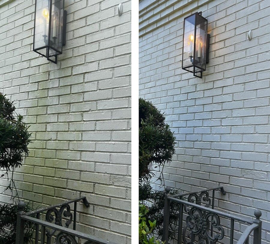 Brick wall of a Mobile home before and after soft washing — green algae on the left, clean white brick on the right