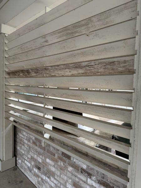 Louvered wooden privacy screen grayed and dirty before cleaning