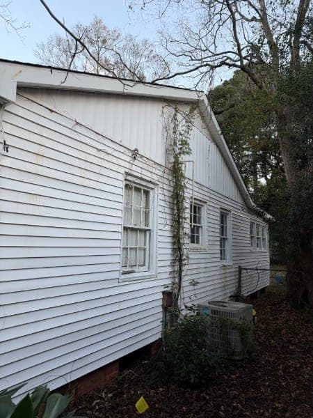 The same siding after soft washing, back to clean white