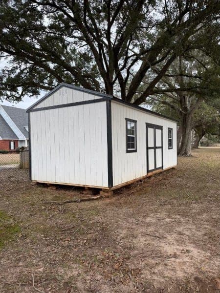 The same storage building after soft washing, walls clean and white