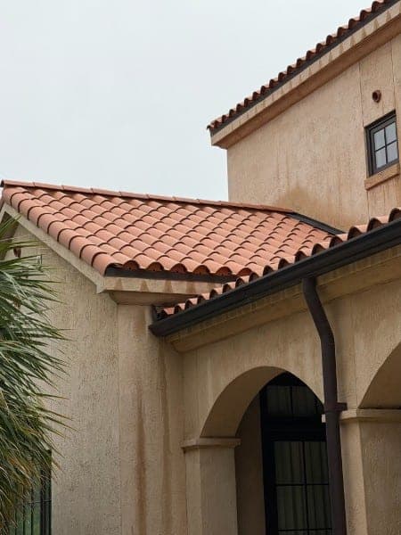 The same clay tile roof after cleaning, tiles back to a bright terracotta